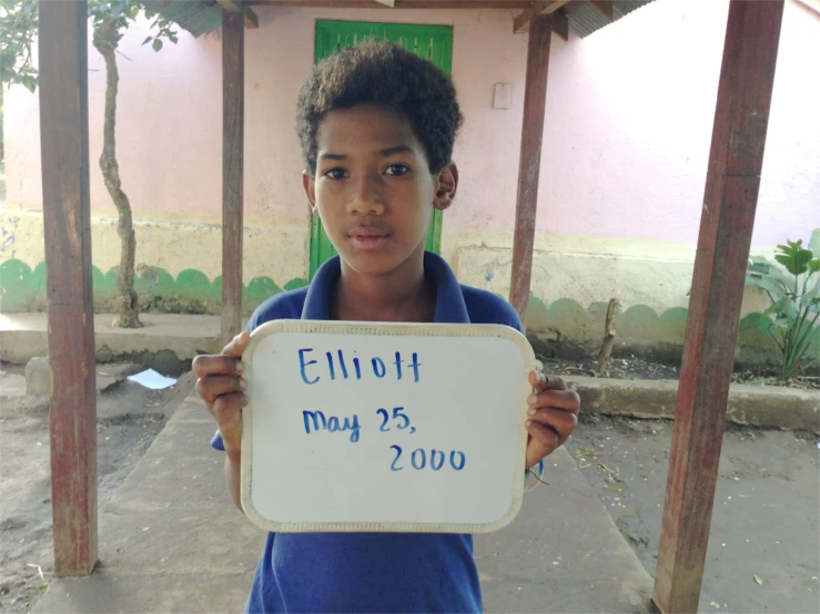 a girl holding up a sign that reads ethiopian may 25th 2010