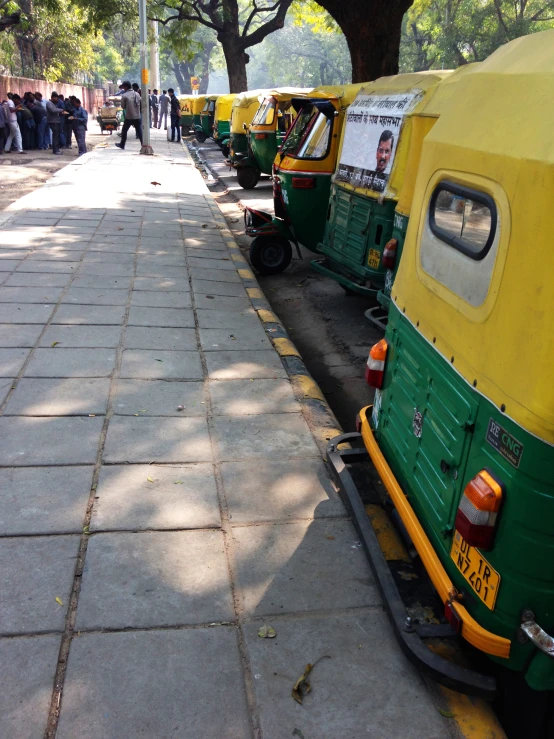 there are many electric vehicles parked near the sidewalk