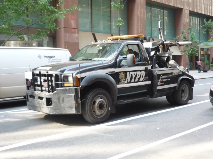 a tow truck carrying two motorcycle trailers