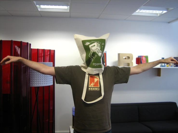 man in paper bag over head posing for the camera