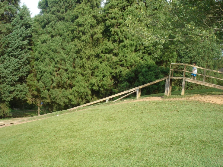 a fence on the top of a grass hill