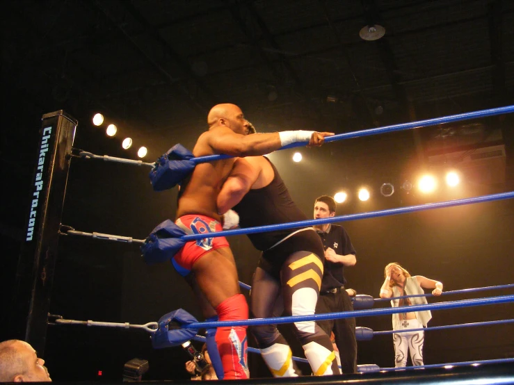 two wrestlers in a ring at an arena