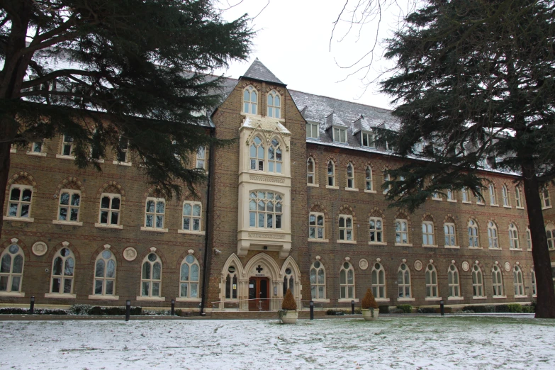 a tall brown brick building has several windows