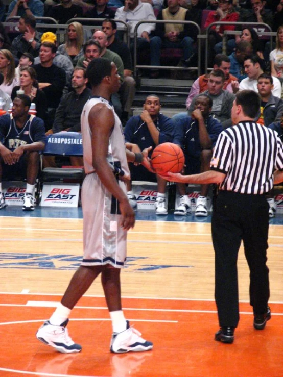 a basketball player in a white uniform is standing on the court