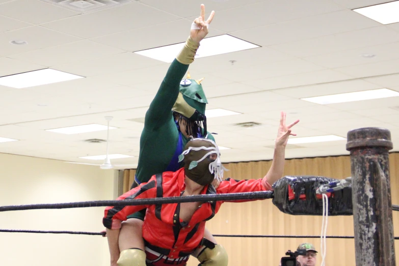 two people on each side of a pole, with one person wearing a mask