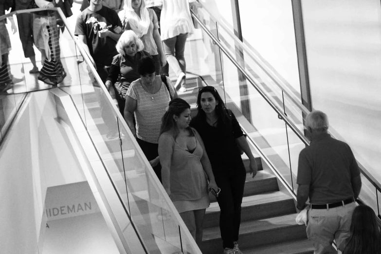 black and white po of several people walking down stairs