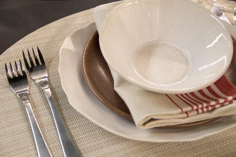 this is a bowl and silverware on a table