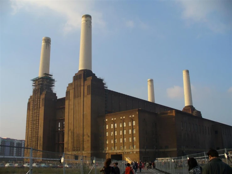 a factory building with many smoke stacks and towers
