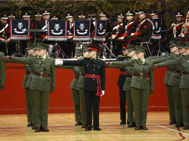 soldiers in uniform are putting their hands together