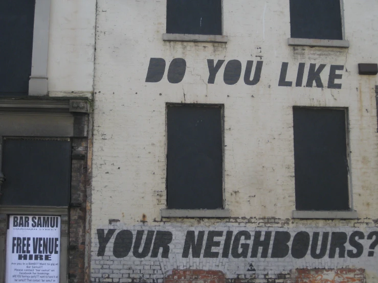 graffiti painted on the wall of a building that reads do you like your neighbor?