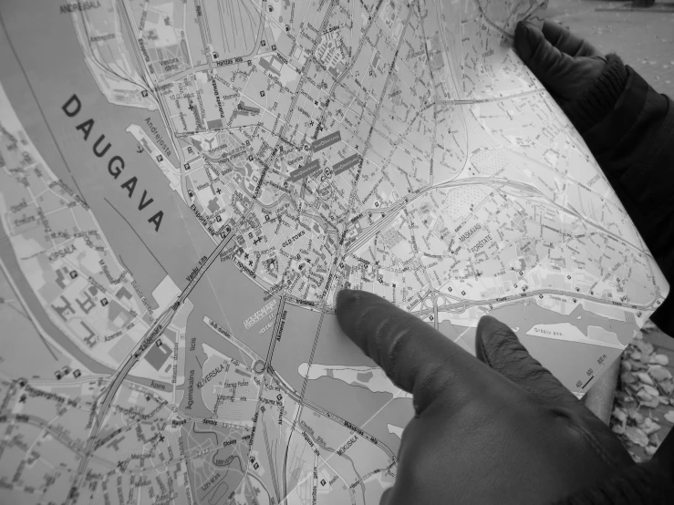 someone pointing at a map with focus on it