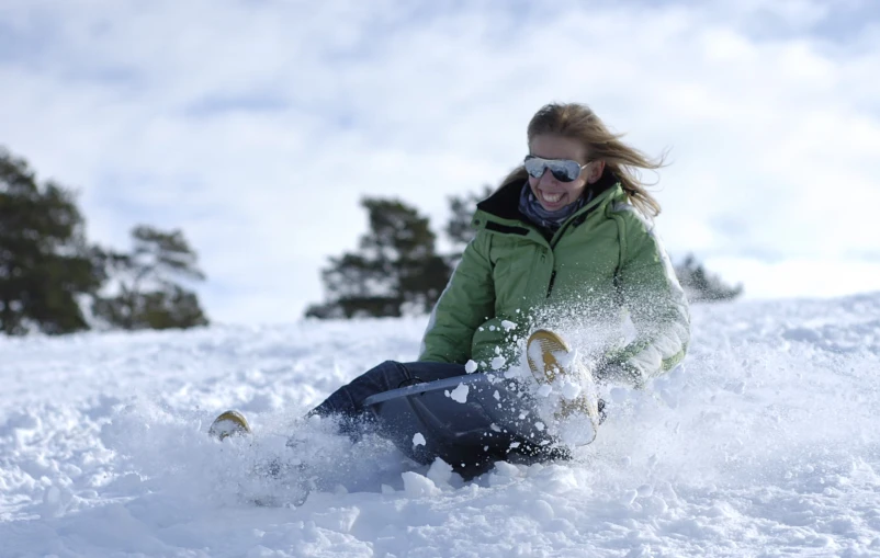 a woman riding skis on a snow covered slope