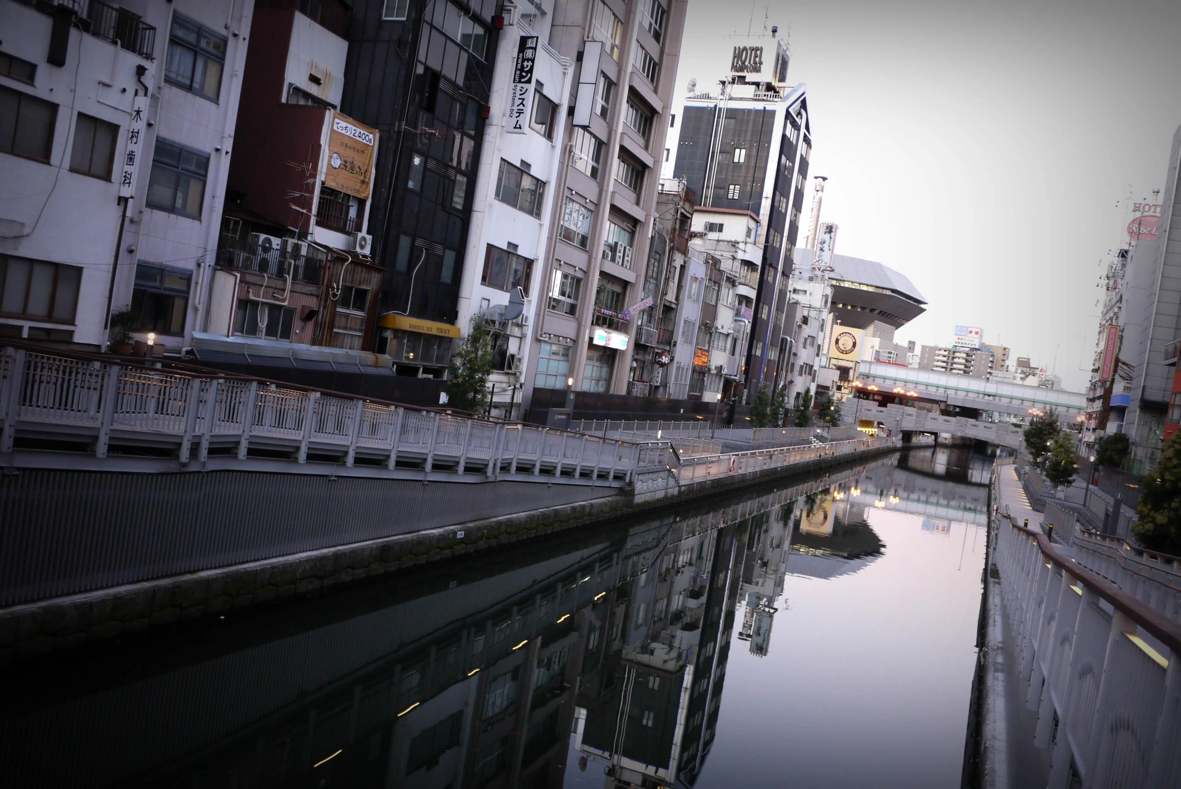 a small canal in a city between tall buildings