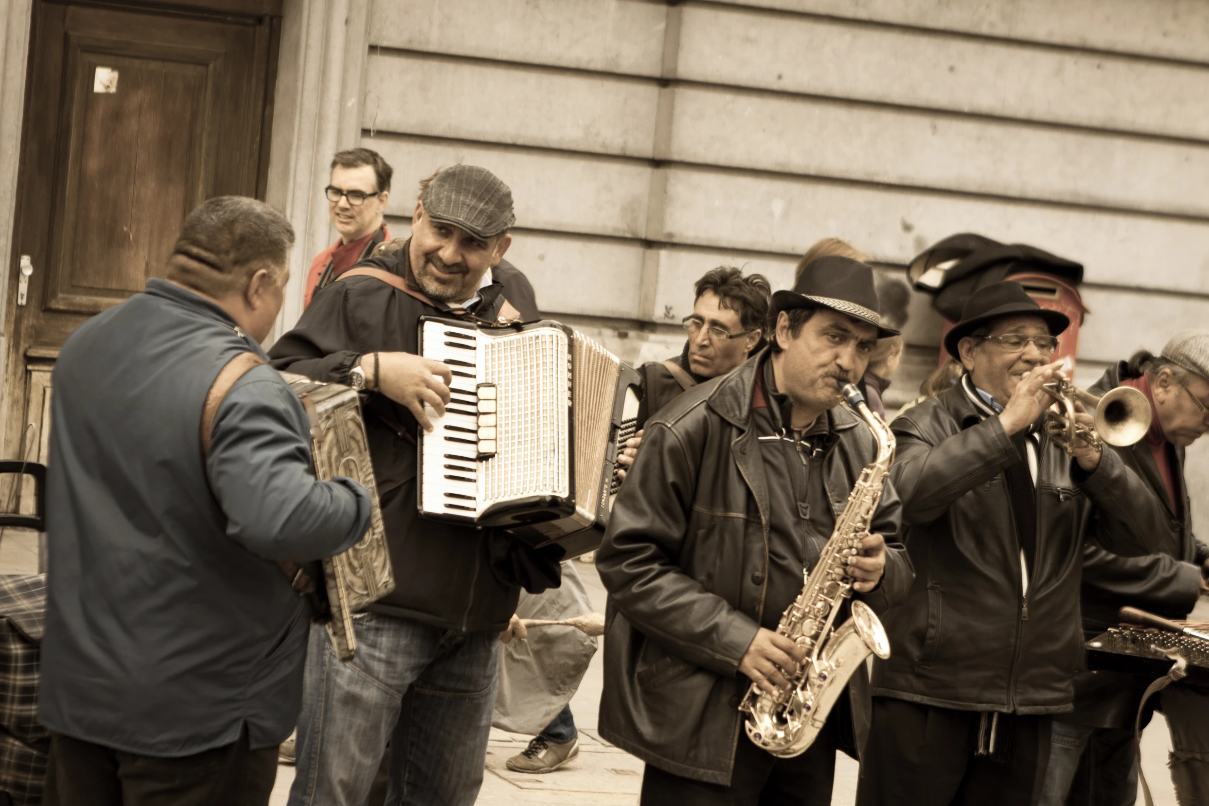 people with accordions and hats, some playing music