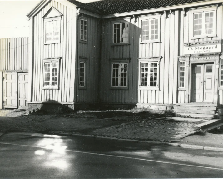 an old wooden building with two balconies and windows