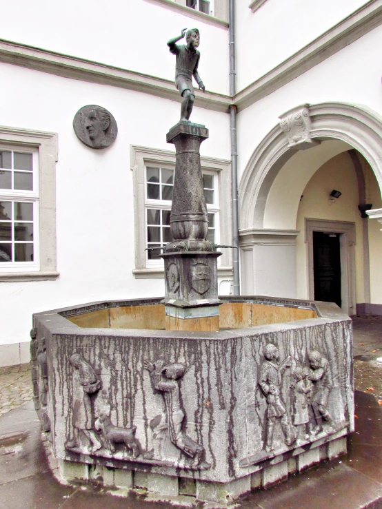 an artistic design with an iron statue in the middle of a courtyard