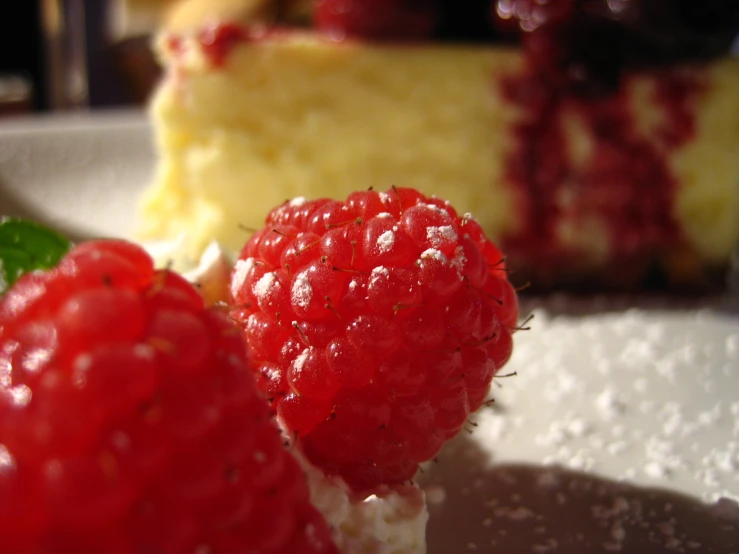 raspberry cheesecake with the remaining piece ready to eat