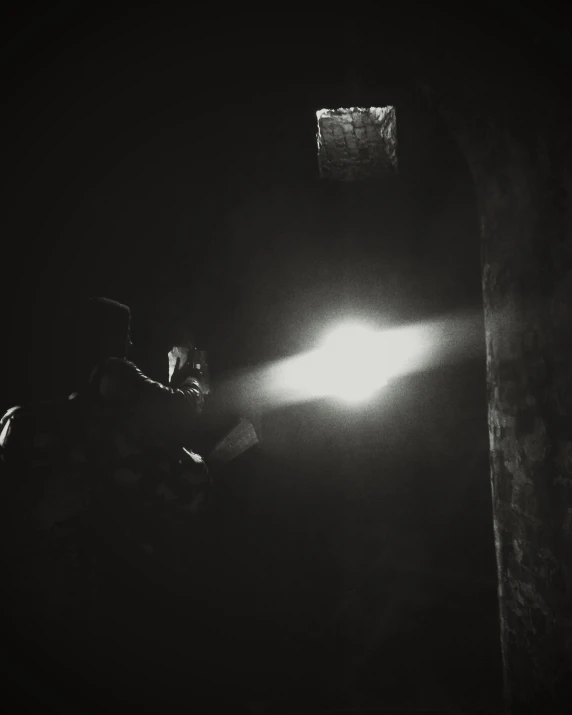 a man sitting at a table next to a lamp