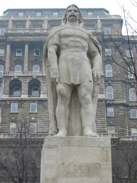 a statue of a man is near a building