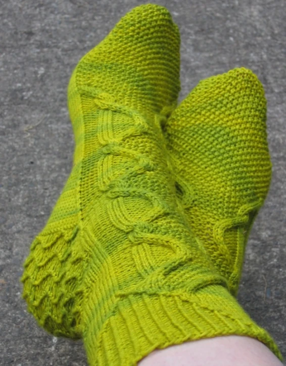 the bottom part of someone's feet in bright green socks