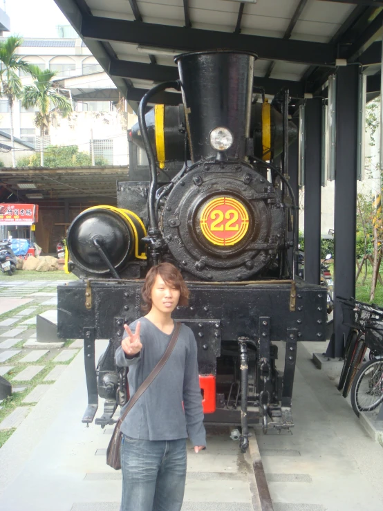 a woman standing next to a very old fashioned machine