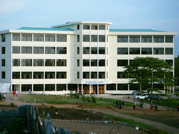 a very big building with some windows and a lot of people