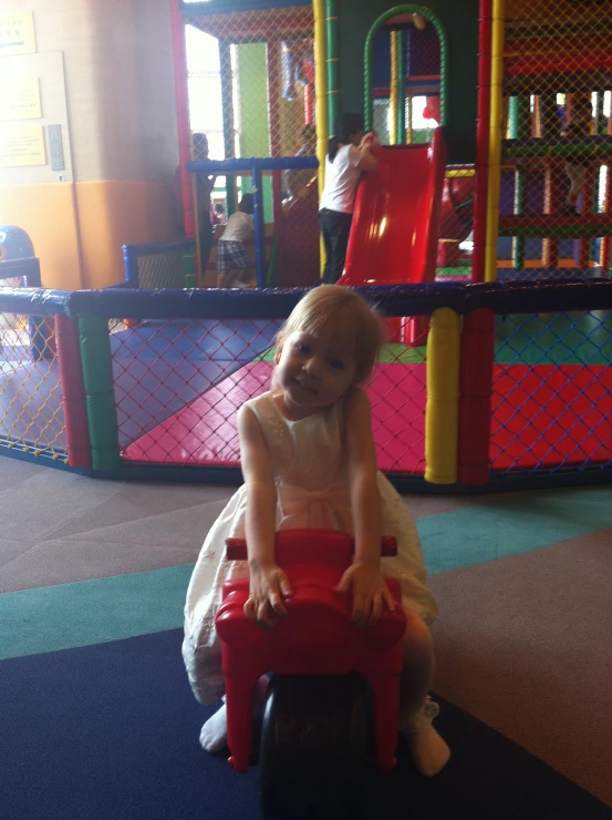 a young child is sitting in a toy park