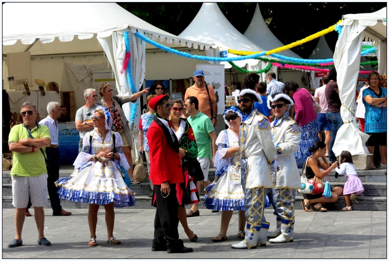 several people dressed in costumes standing around