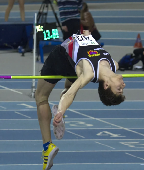 a male athlete in mid jump during a race