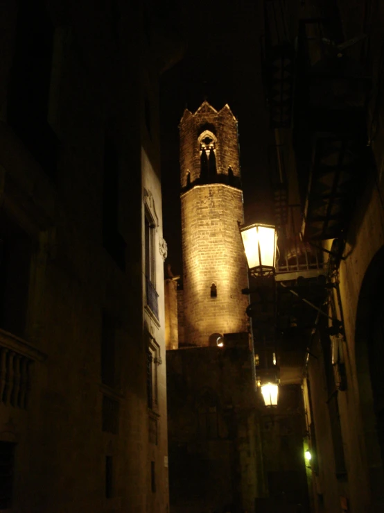 a stone clock tower lit up at night