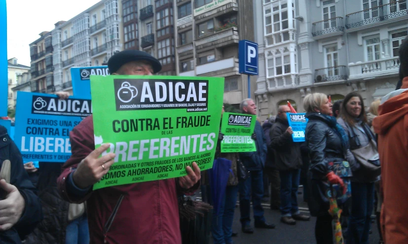 several people hold signs while standing in the street