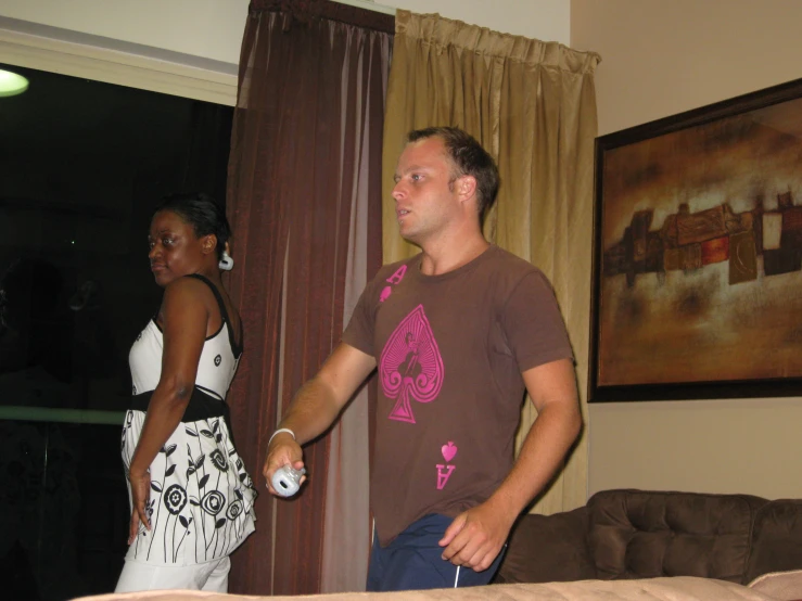 a man and woman are playing with the wii