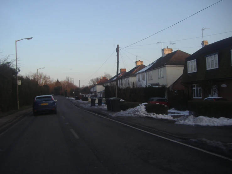 a car is parked on the street near some houses