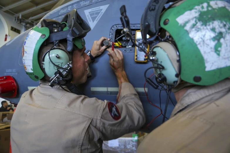 the pilots are wearing headphones on each of their heads