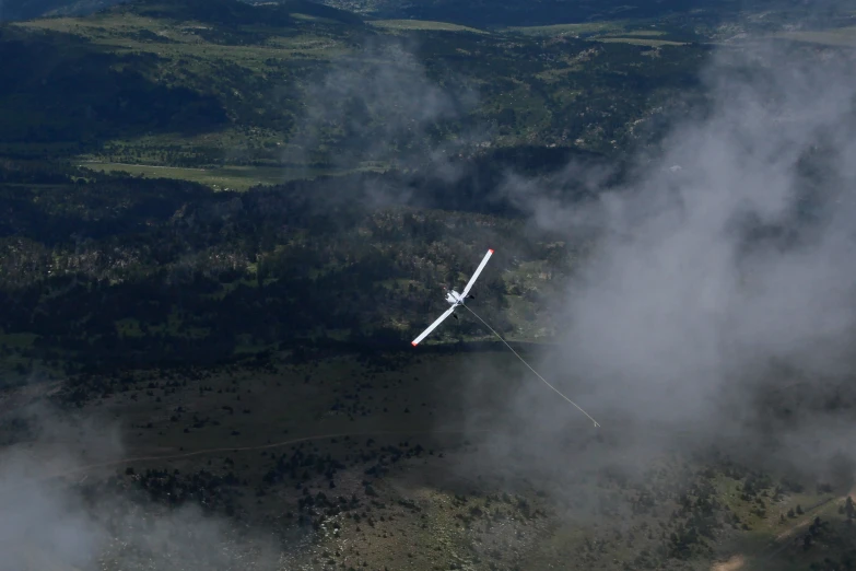 a picture of a plane flying high above the clouds