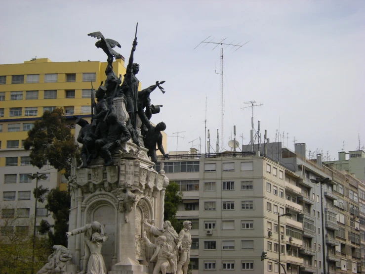 a statue with many birds sitting on it's back