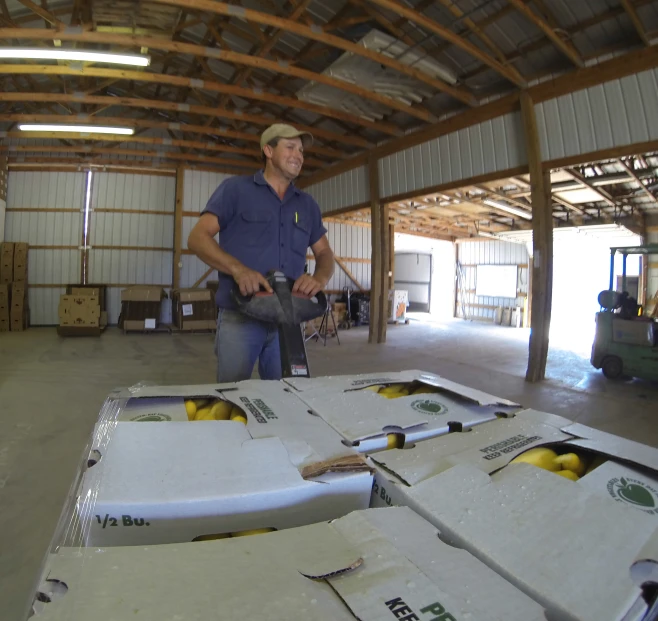 a man standing inside a large building with white boxes