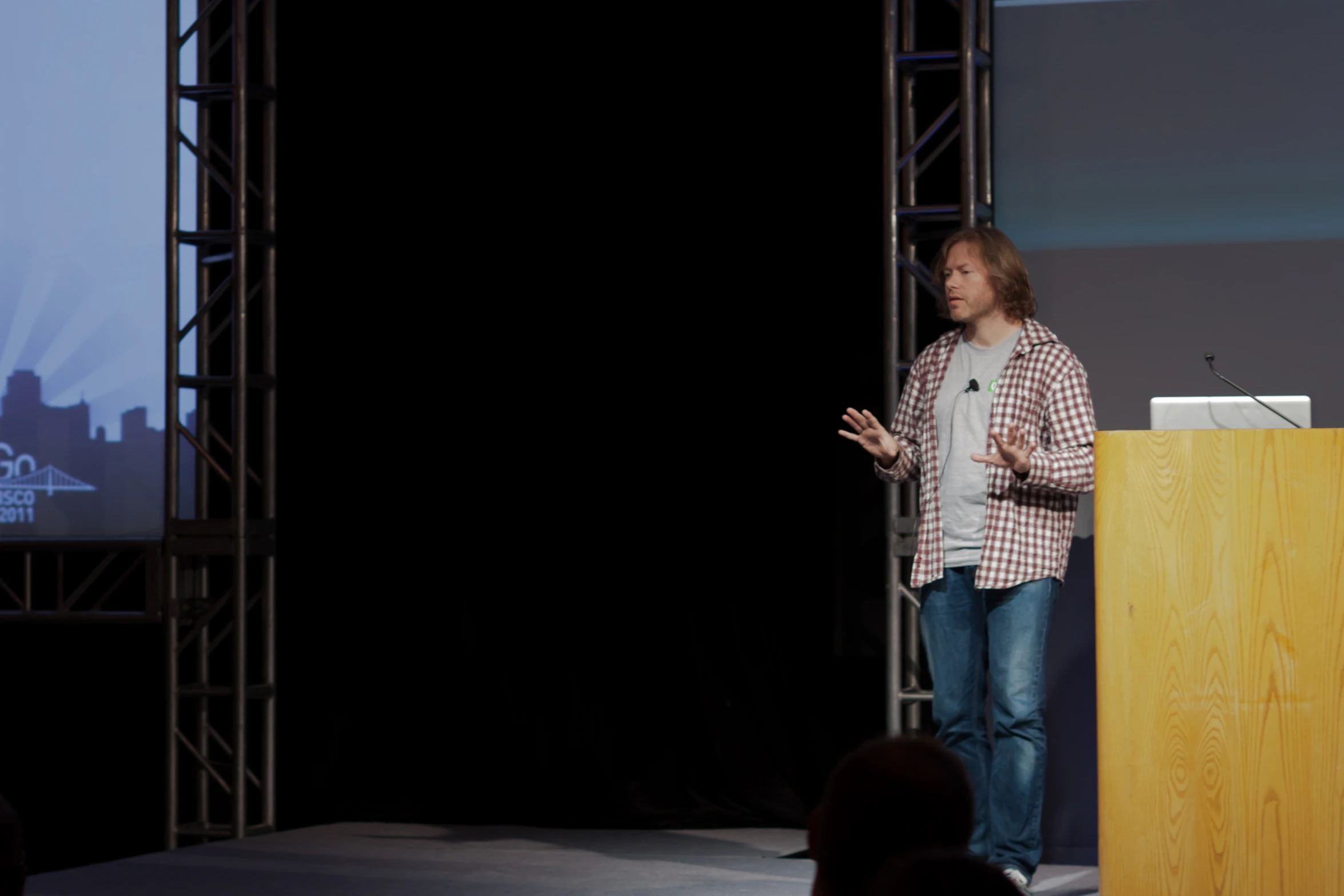 a man standing at a podium giving a presentation