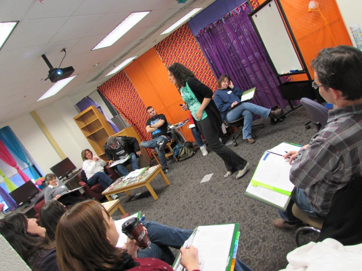 a group of people sitting on chairs in front of a room