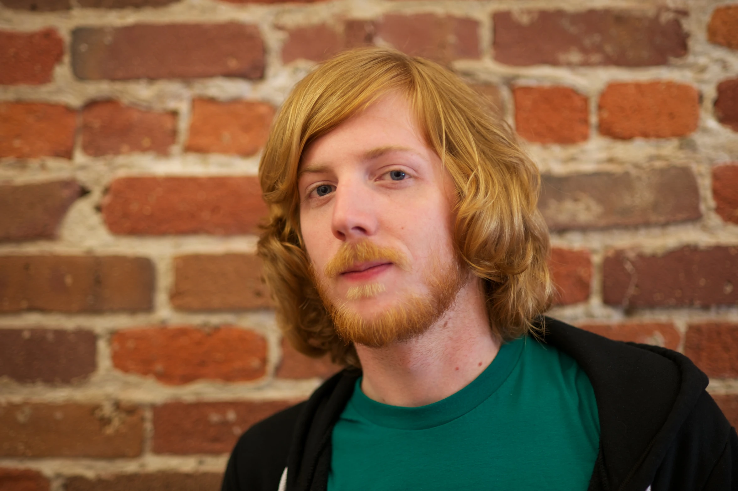 a man with a beard and wearing a green shirt