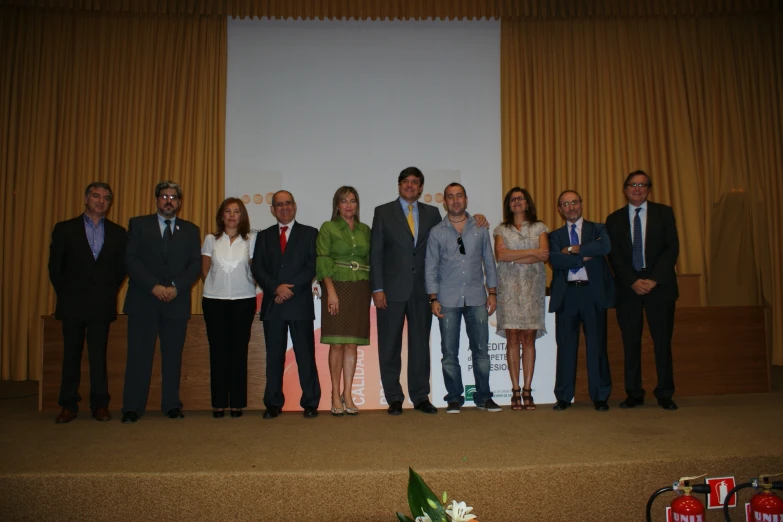 several people in suits and ties are posing for a group po