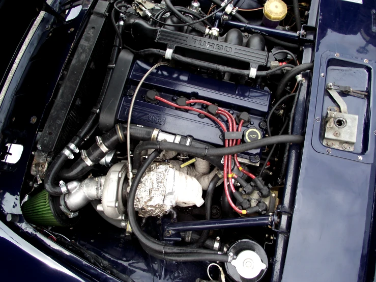 the engine compartment in a car is loaded with assorted pipes