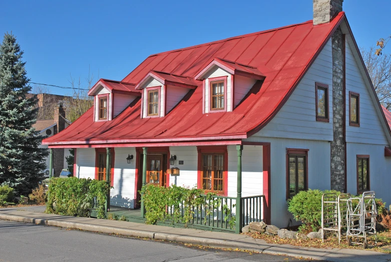 two story house with red tin roof and white trim