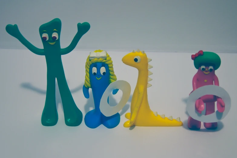 a set of three plastic toy figures on top of a table