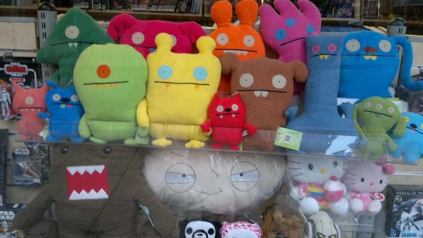 many different stuffed animals are in a store display