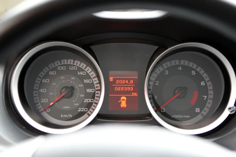 a meter and clock on a car's dashboard