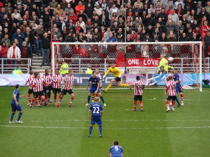 several soccer players are playing in front of an audience