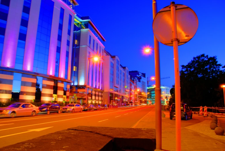 a street is lit up with colored lights