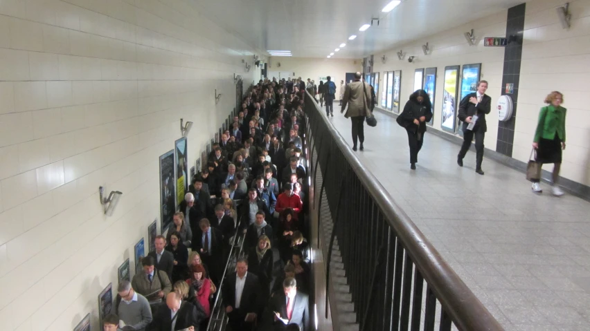 a group of people walking on an indoor stairway