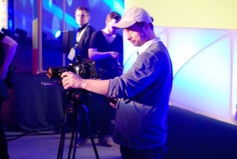 a man holding a camera and filming a performance